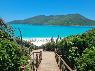 Escadarias (Stairway) Prainhas do Pontal do Atalaia: a Brazilian Caribbean paradise with crystal-clear waters, white sandy beaches, lush vegetation, and islands — Staircase perfect for trip photos.
