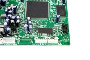 A close-up of the processor microchip surrounded by other electrical components on a green circuit...