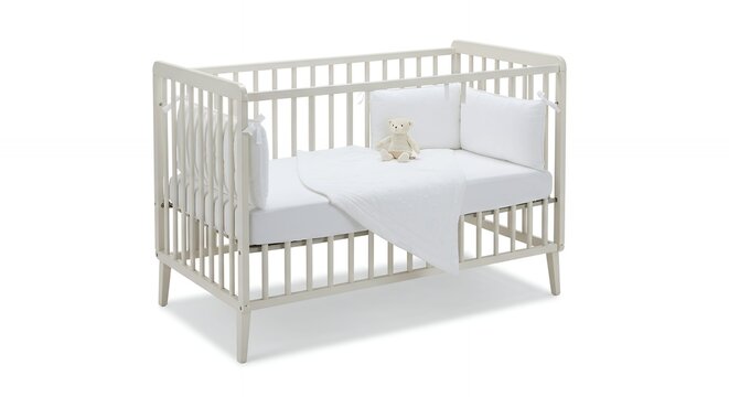 Light gray wooden baby crib with white bedding