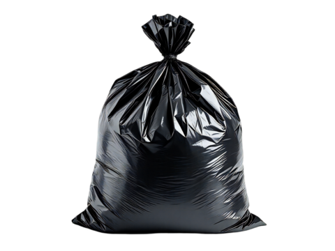 Close up of a tied black plastic garbage bag filled with trash against a black background studio shot
