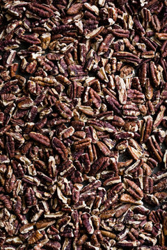 A close-up view of a pile of shelled pecans.