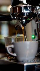 Close up of fresh espresso flows from coffee machine