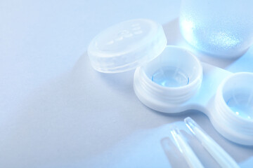 Case with contact lenses on white background, closeup. Space for text