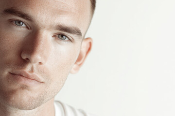 portrait of young man with concentrated expression located in upper right corner of frame
