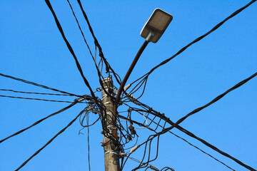 An electric power lines on a high voltage pole on a street may look dangerous