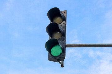 Traffic light with cloudy sky background