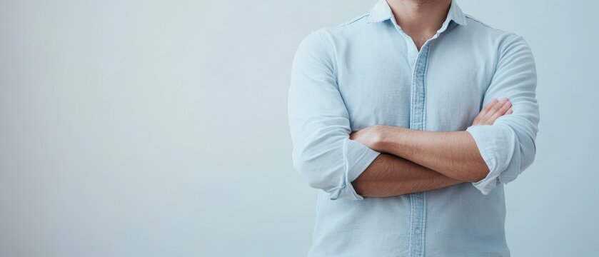 Person with crossed arms in relaxed pose indoors
