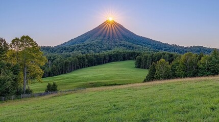 Fototapeta premium Sunrise over Green Meadow and Mountain Peak