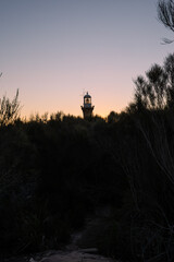 Silhouette of lighthouse at sunset time.