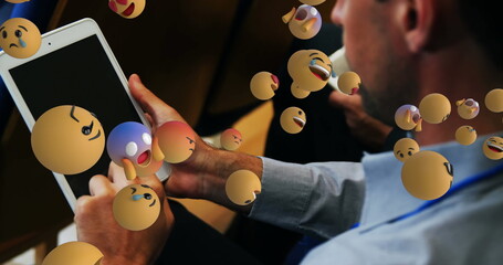 Blue shirt attendee interacting with tablet at seminar room, with floating 3D emoji, copy space