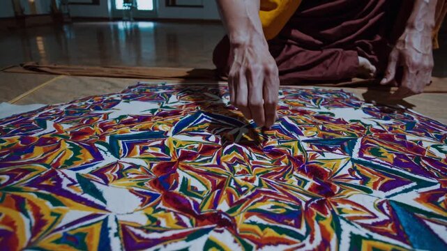Monk Brushing Away Colorful Sand Mandala.
