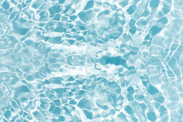 Blue water with ripples on the surface. Defocus blurred transparent blue colored clear calm water surface texture with splashes and bubbles. Water waves with shining pattern texture background.