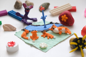 Child making crafts using natural dry plants, flowers, grass, leaves and use plastic corks, stones, plasticine, beads and paper. Back to school. Making diorama. Ideas for children's art