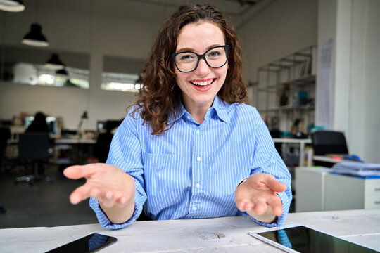 Web cam view of happy young business woman leader, coach, hr manager talking to web camera having online job interview, remote video conference call or leading work webinar sitting in office.