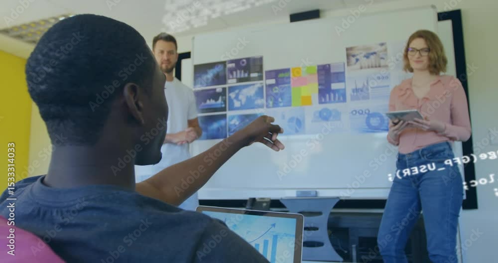 Poster seated developer pointing chart and generating code overlay as team analyzing data in tech meeting