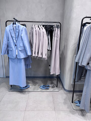 A showcase of stylish women's clothing with suits and skirts in a modern retail store