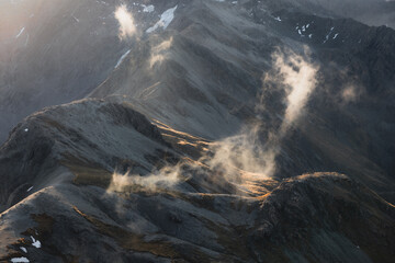 Clouds catching light high in a mountain valley