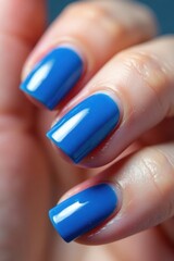 Gel nail polish in blue shade on finger tips with blurred texture effect, beauty products, gel nails