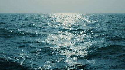 Fototapeta premium The calm sea, light blue-green tones, and the tranquil underwater view, where the sunlight reflects off the water's edge, creating a tranquil atmosphere. Gentle ripples and silence on the sea.