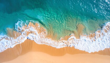 Fototapeta premium Aerial view of pristine beach with turquoise water washing over golden sand, capturing the serene beauty of nature.