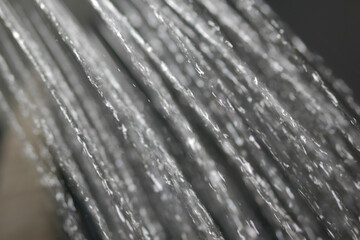 Water stream from a showerhead in a modern bathroom