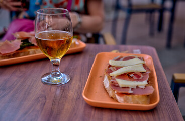 Madrid, Spain - June 1, 2025: Tapas and beverages on a restaurant patio table in the Getafe district in Madrid in Spain
