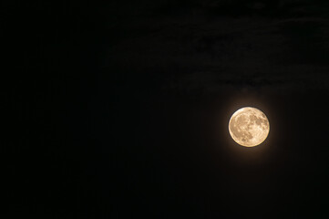 Bright Strawberry Full Moon in Night Sky