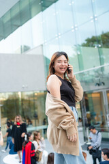 Fototapeta premium Beautiful smart business asian woman use smartphone in modern city office building
