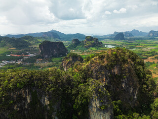 Obraz premium Aerial Landscape of Limestone Cliffs and Green Farmland in Krabi Thailand