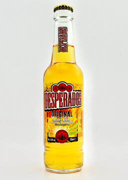 A closeup of a bottle of Desperados beer isolated against a white background.