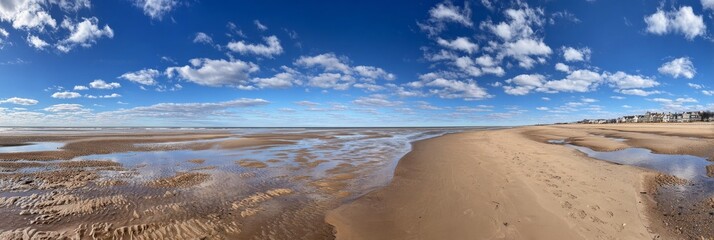 Minimalist scene of a flat beach with wet sand, reflecting ambient light. 