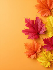 Autumn leaves in red, orange, and yellow colors arranged on warm orange background, creating cozy seasonal atmosphere