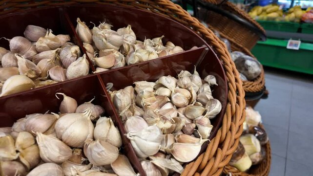 Fresh garlic displayed in a market basket for shoppers