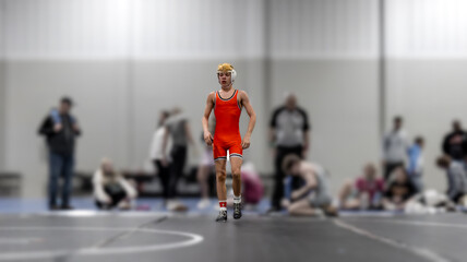 Focused Wrestler Approaches Mat After Ending A Match – Youth Wrestling Tournament Indoors

