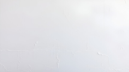 A white wall with peeling paint, notably chipped at the top and bottom edges