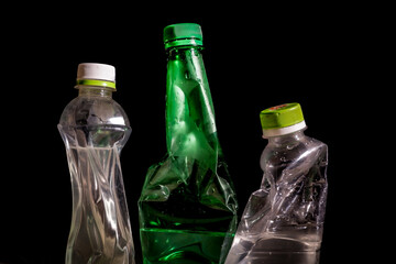 Crushed Plastic Bottle Trash Isolated on Dark Background – Environmental Waste Concept