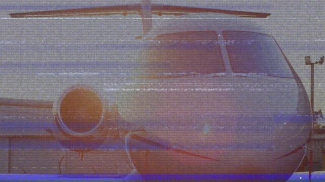 After static glitch, camera slowly zooming into jet nose and engine showing windows and fuselage