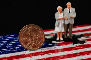 US $1 coin, elderly couple and American flag made from puzzle pieces