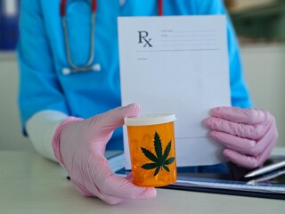 Medical professional holding a prescription and cannabis container