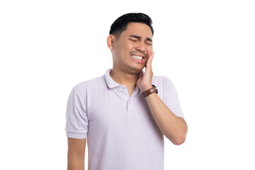 Young man suffering from toothache touching his cheek in pain while wearing casual shirt isolated...