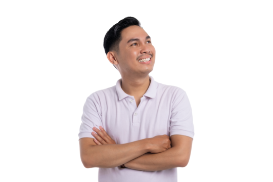 Confident young man smiling and looking up with folded arms wearing casual polo shirt isolated on transparent background