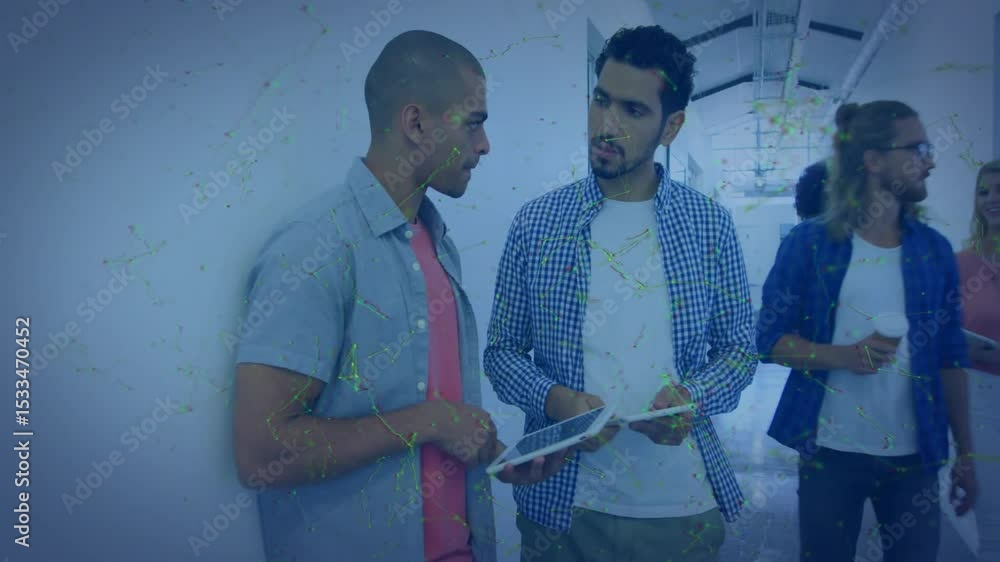 Poster two men reviewing tech project in corridor rotating tablet and showing animated charts on screen