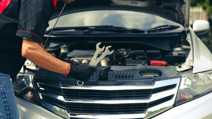 Auto mechanic holding the wrench for fix service repairing change spare part engine problem or...