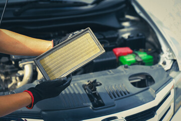 Auto mechanic holding car air conditioner filter for check and clean dirty or fix repair heat have...
