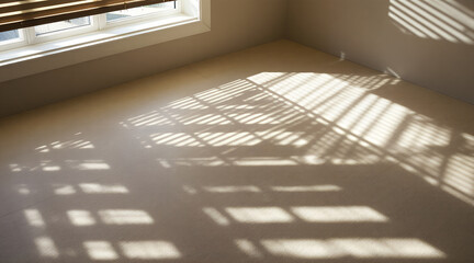 Obraz premium Sunlight Streaming Through Blinds Creates Abstract Shadows on a Beige Floor