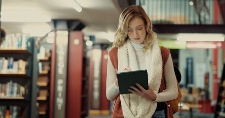 Student, online and woman with tablet, library and browsing on web for research, study or...
