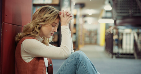 Fototapeta premium University, girl and stress on library floor for academic burnout, student loans or study fatigue. Education, anxiety and person with depression on campus for workload pressure or overwhelmed by exam