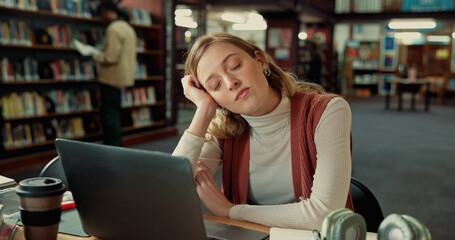 College student, tired and sleeping with laptop in library for study fatigue, burnout or...
