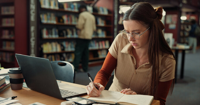 Laptop, writing and college with woman in library for education, future and student life. Assignment resources, online portal and study habits with person on campus for scholarship application