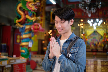 Respectful tourist exploring a traditional religious shrine during a cultural trip.